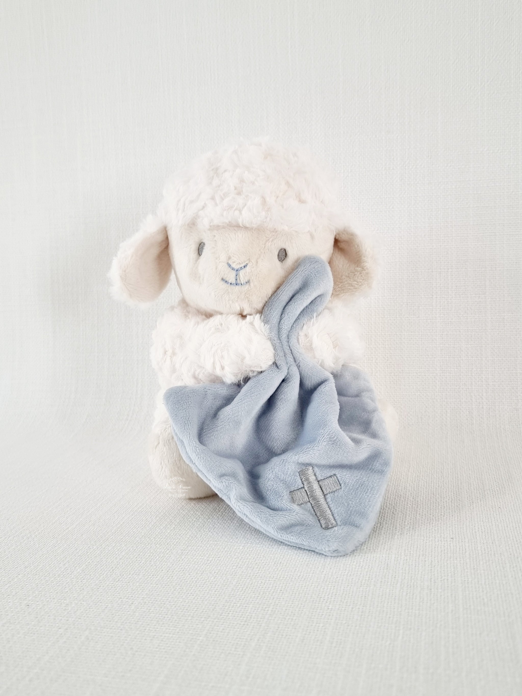 Press to hear 'Jesus Loves Me' Sitting Lamb and Cross Blanket Plush Toy by Demdaco